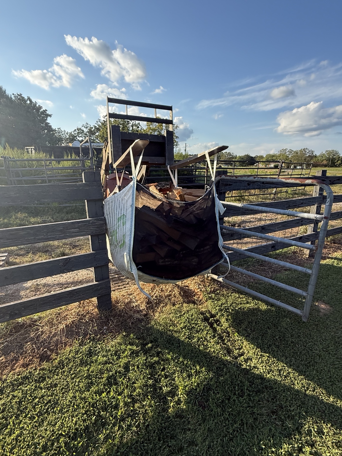 Oak Hill Firewood delivering a large bag through a gate