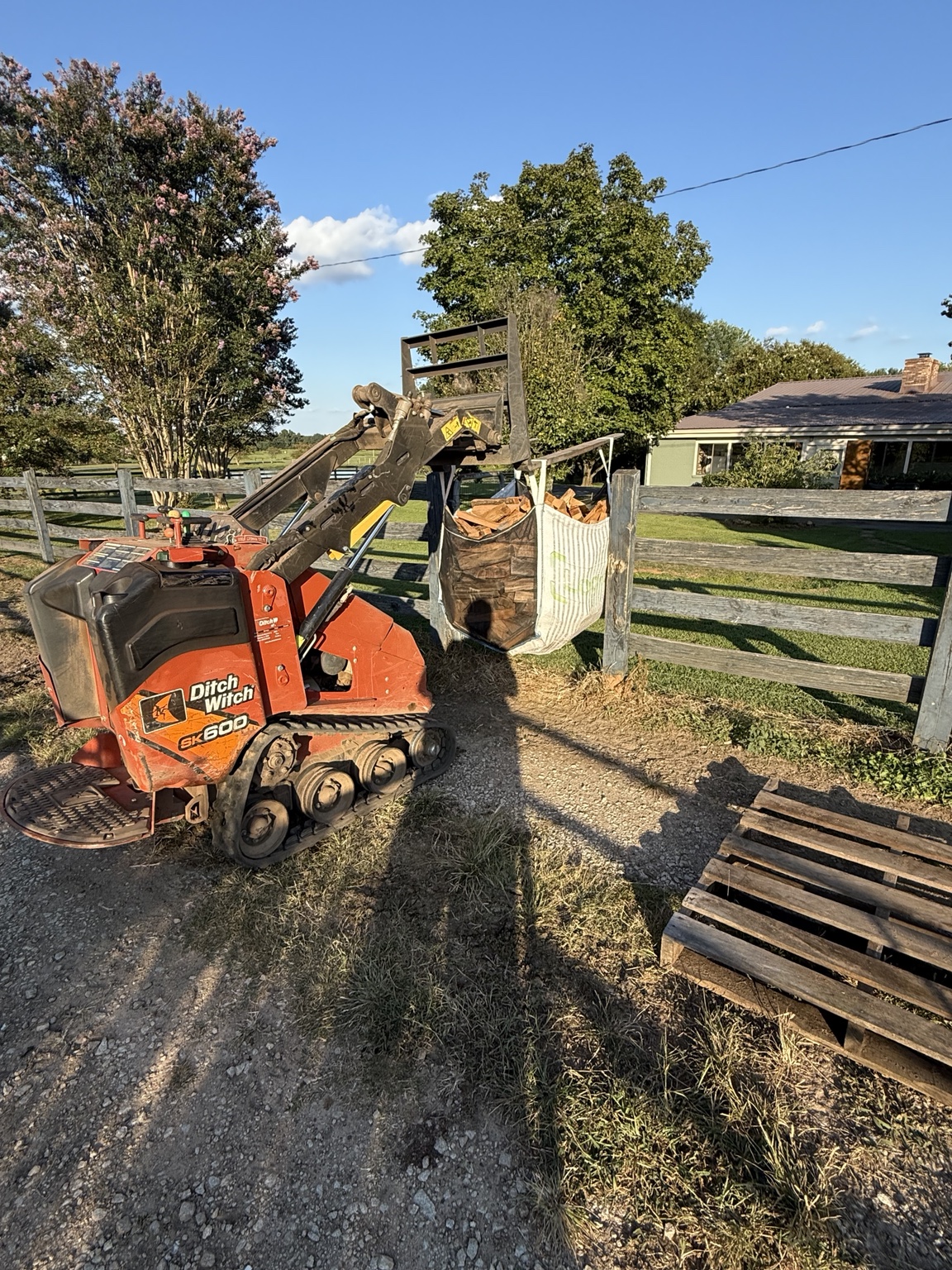 Compact tracked loader used for firewood delivery
